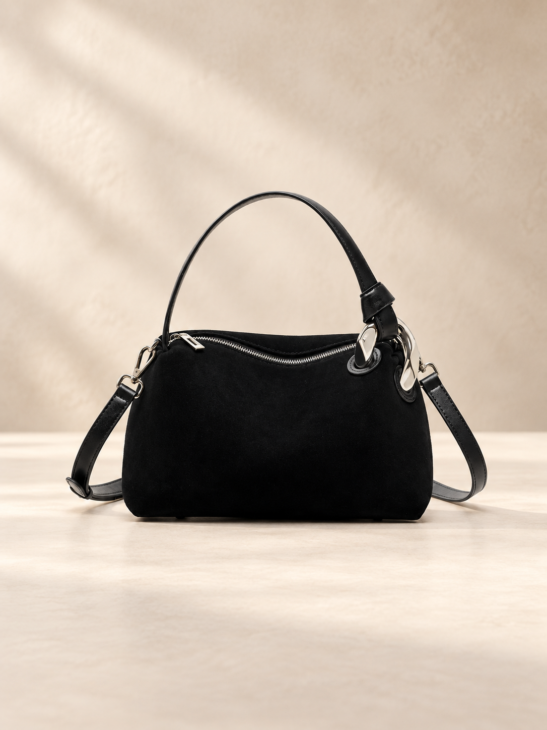 JXR4001 black suede-finish leather tote on a warm ivory-beige studio background