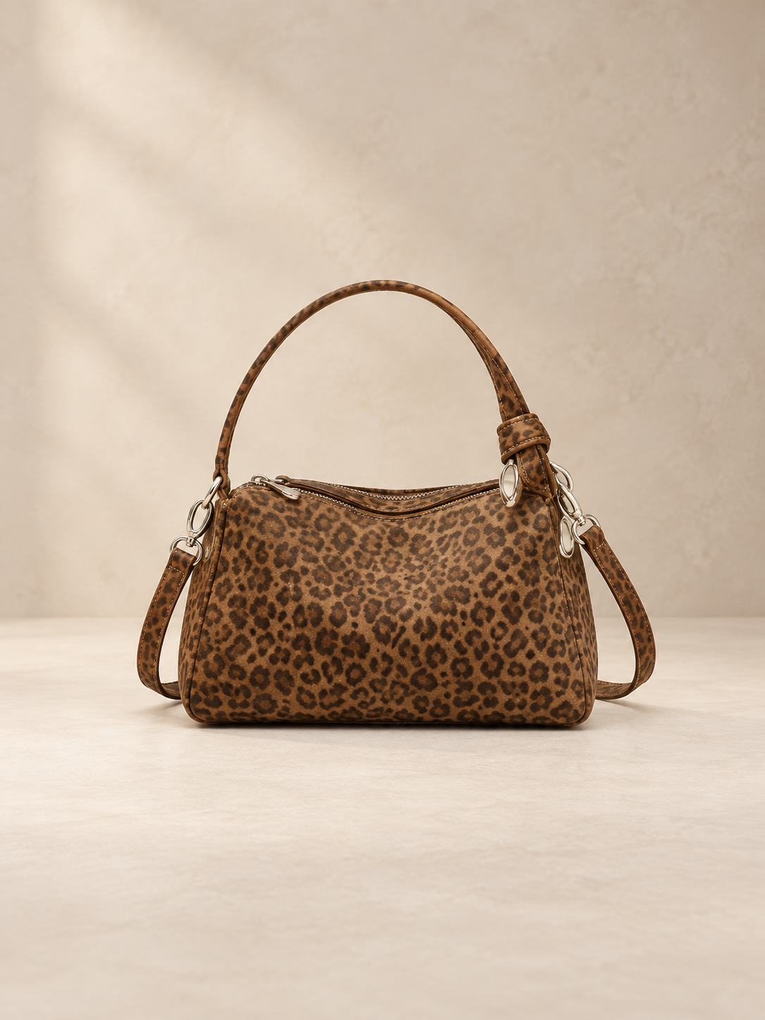 JXR4001 leopard-print suede-finish leather tote on a warm ivory-beige studio background