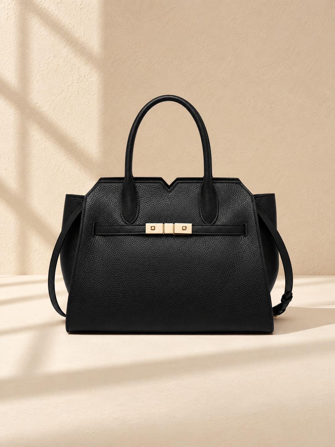 JXR4003 black top-grain leather tote on a warm ivory-beige studio background