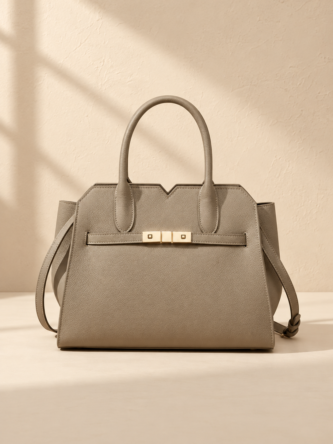 JXR4003 elephant-grey top-grain leather tote front view on a warm ivory-beige studio background